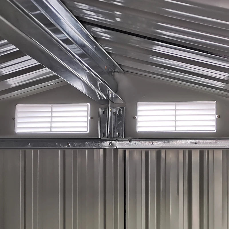 Image of a small green metal garden shed with an apex roof and single sliding door