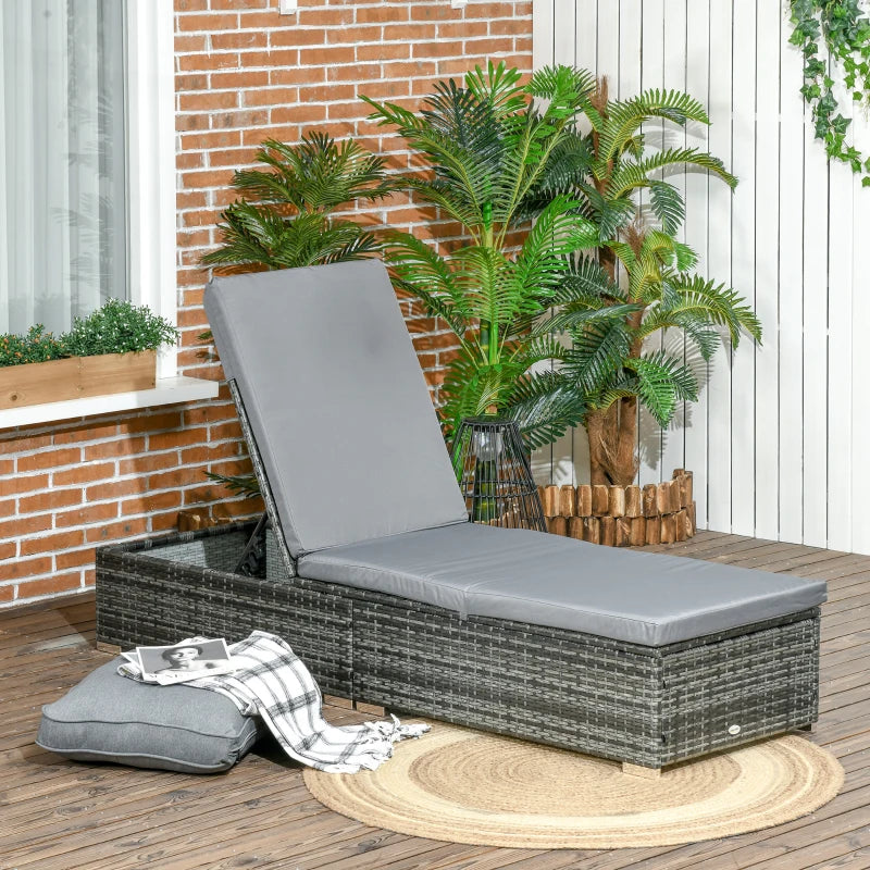 Image of a reclining rattan sun lounger with a grey cushion