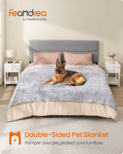 German Shepherd resting on the Grey Ombré Waterproof Dog Blanket spread over a bed