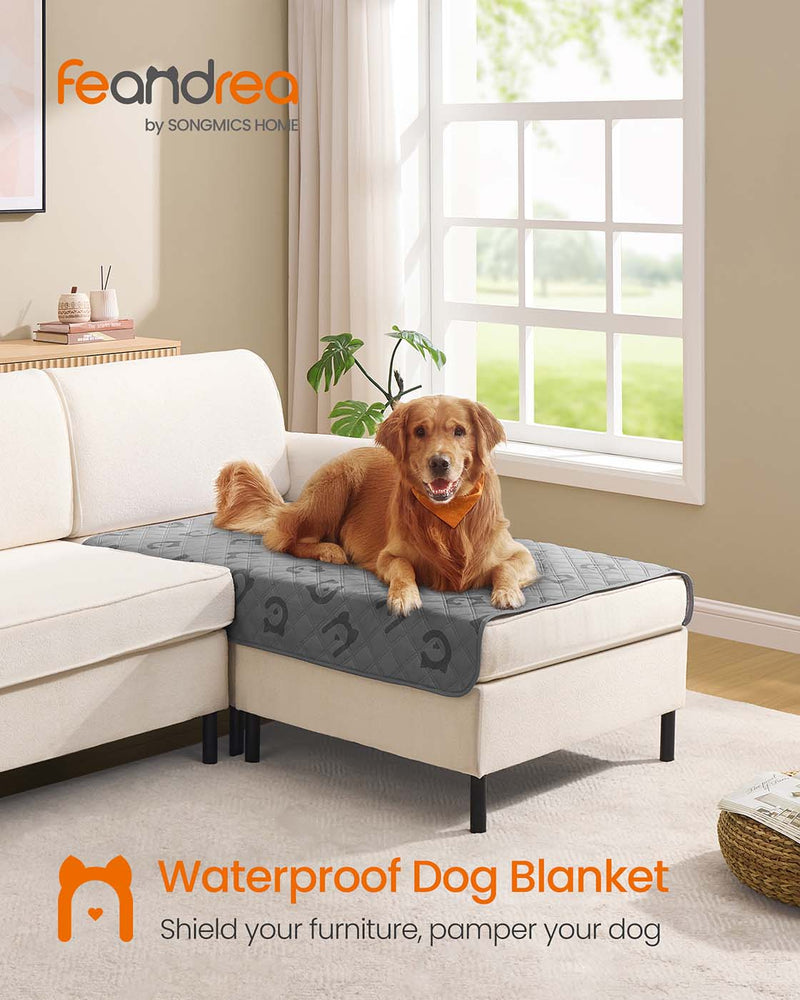 Golden Retriever lying on the Dove Grey Waterproof Dog Blanket draped over an ottoman
