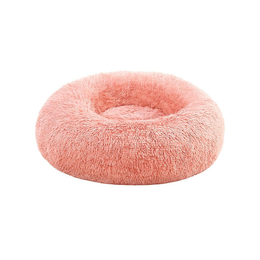 Image of a round pink fluffy dog bed