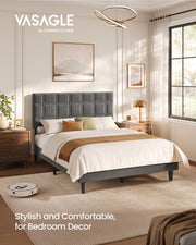 Vasagle upholstered double bed in a bright bedroom with a robot vacuum passing under the raised frame