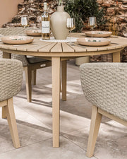 Roma terrazzo dining set on a patio with sand-toned Eden Dawn chairs
