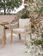 Roma round acacia dining table and rope chairs on a patio