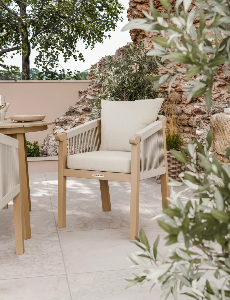 Roma round acacia dining table and rope chairs on a patio