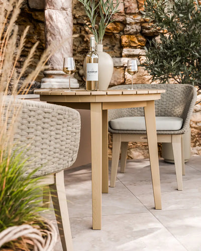 Roma acacia bistro table and Eden Dawn chairs on a patio