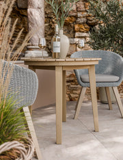 Roma acacia bistro table and Sol rope chairs on a patio