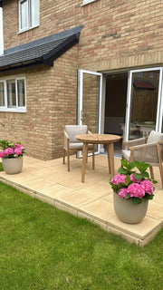 Roma 2 seater acacia bistro set in a garden
