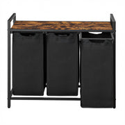 3 black laundry bags on a wooden top shelf with a metal frame.
