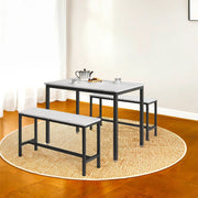 Marble-effect dining table and two benches on a round rug