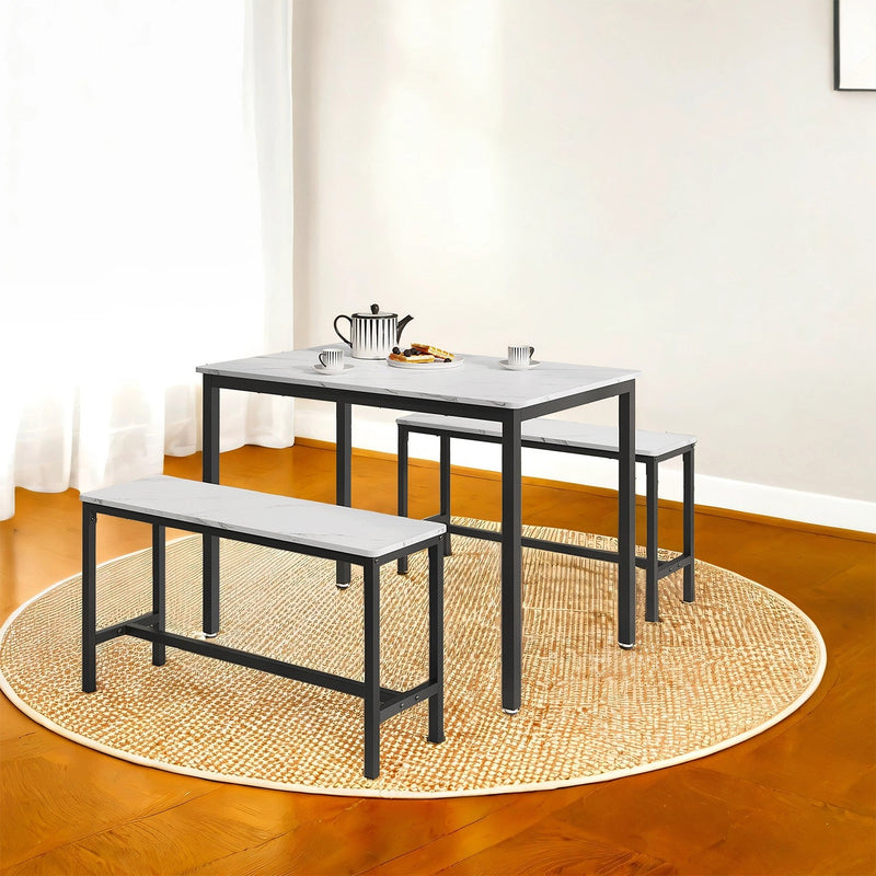 Marble-effect dining table and two benches on a round rug