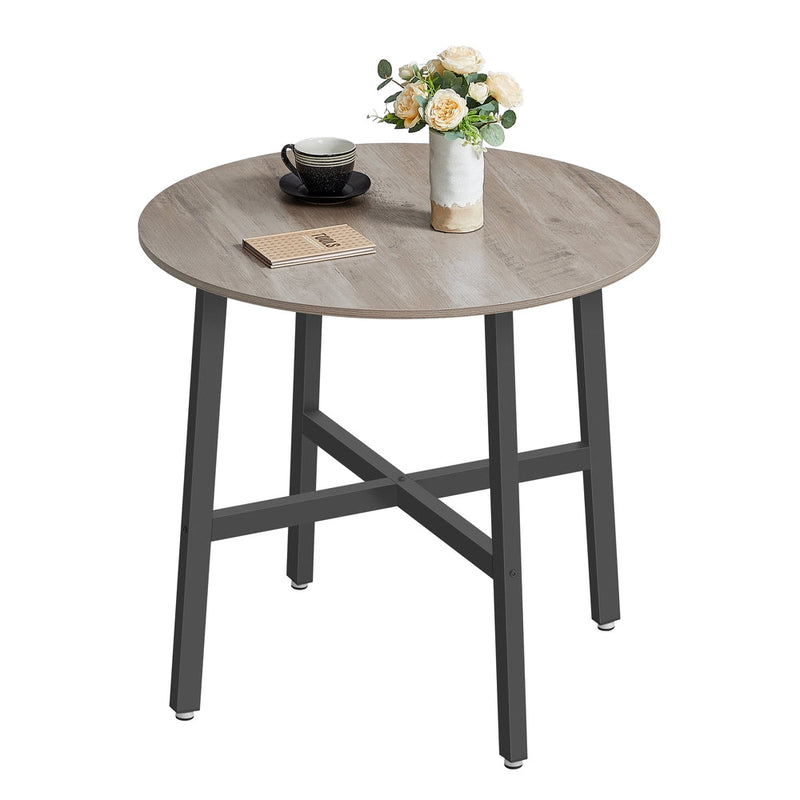 Heather Greige round table top styled with a coffee cup, book and vase of roses