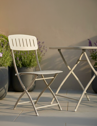 Venice cashmere cream folding bistro set on a patio