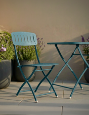 Venice Caribbean blue folding bistro set on a balcony