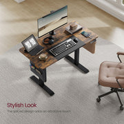 Image of a Vasagle Electric Height Adjustable Standing Desk With a Rustic Brown Tabletop, Black Metal Frame and Legs and a Side Pouch For Books and Stationary