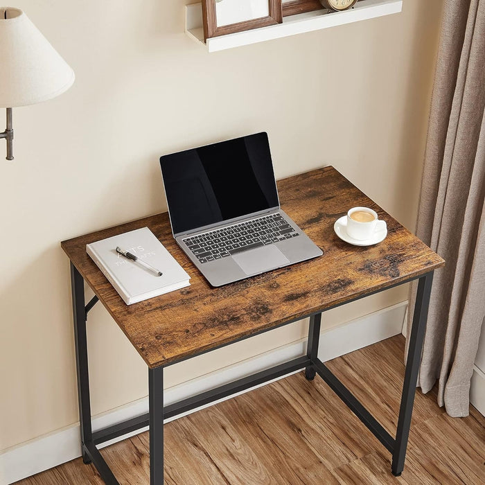 Image of a small desk for small spaces with a rustic brown tabletop and a black frame and legs. 