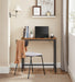 Image of a small desk for small spaces with a rustic brown tabletop and a black frame and legs. 