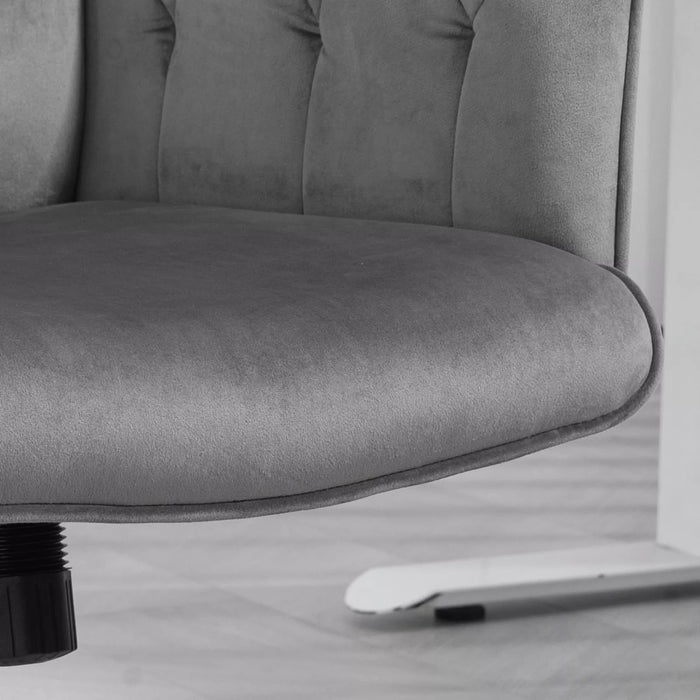 Image of a velvet grey desk chair with button tufted back and swivel wheels