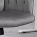 Image of a velvet grey desk chair with button tufted back and swivel wheels