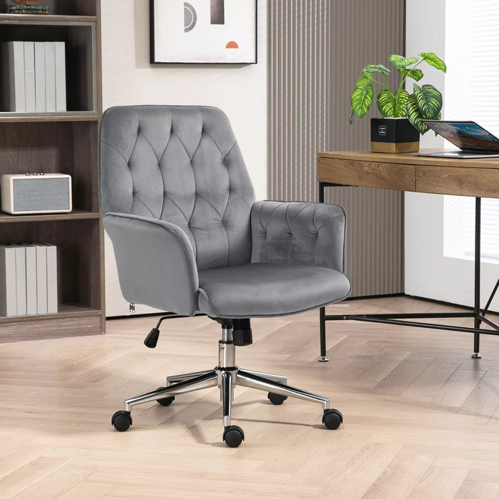 Image of a velvet grey desk chair with button tufted back and swivel wheels