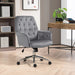 Image of a velvet grey desk chair with button tufted back and swivel wheels