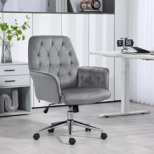 Image of a velvet grey desk chair with button tufted back and swivel wheels