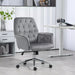 Image of a velvet grey desk chair with button tufted back and swivel wheels