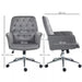 Image of a velvet grey desk chair with button tufted back and swivel wheels