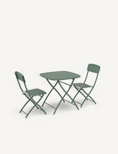 Green folding table and chairs on a white background