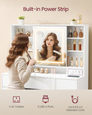 Woman using a hair dryer in front of a vanity mirror with built-in power strip features.