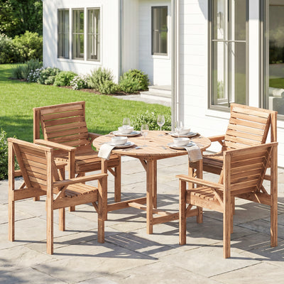 Wooden outdoor dining set with table and chairs on a patio in front of a house.