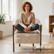 Woman sitting cross-legged on the wide seat of the accent chair