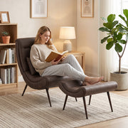 Woman reading in the accent chair beside a bookshelf and lamp