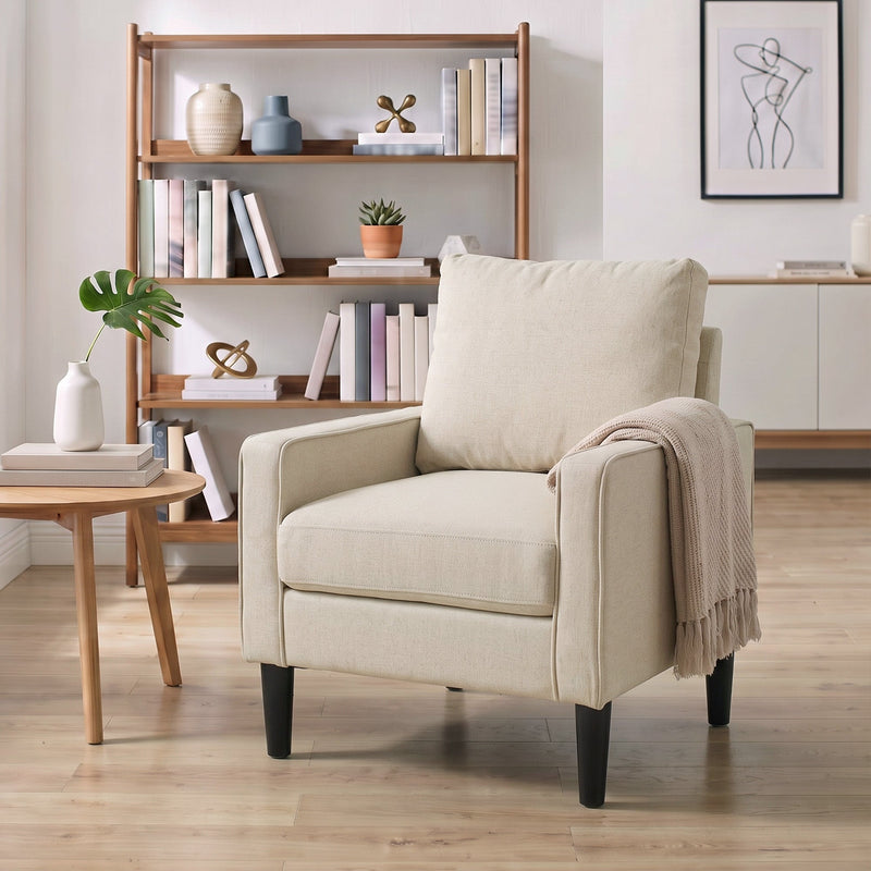 Cream accent chair in a living room with a knitted throw over one arm