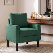 Dark green accent chair beside a dressing table in a bedroom