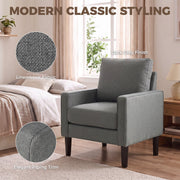 Dark grey linen-look fabric and piping trim shown close up beside the chair in a bedroom