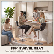 Four people at a marble island with two black stools marked as 360 degree swivel seats