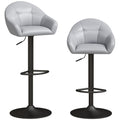 Two grey faux leather bar stools with wraparound backs and black bases on a white background