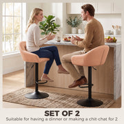 Two blush pink bar stools seating a couple at a kitchen island