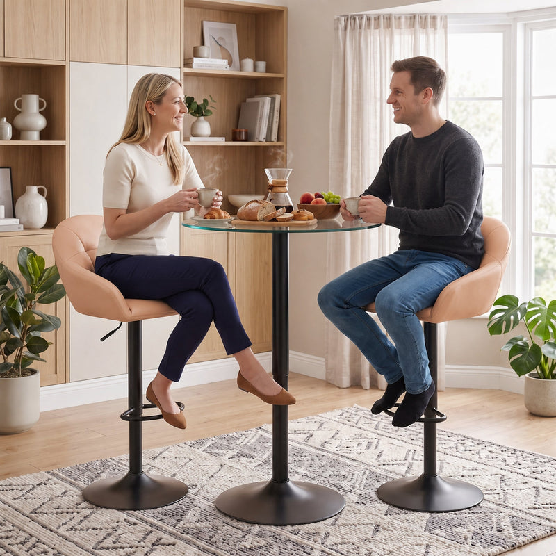 Blush pink bar stools at a round glass breakfast table