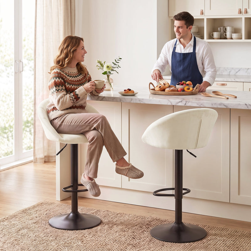Woman sitting on a cream white Homcom bar stool at a marble kitchen island