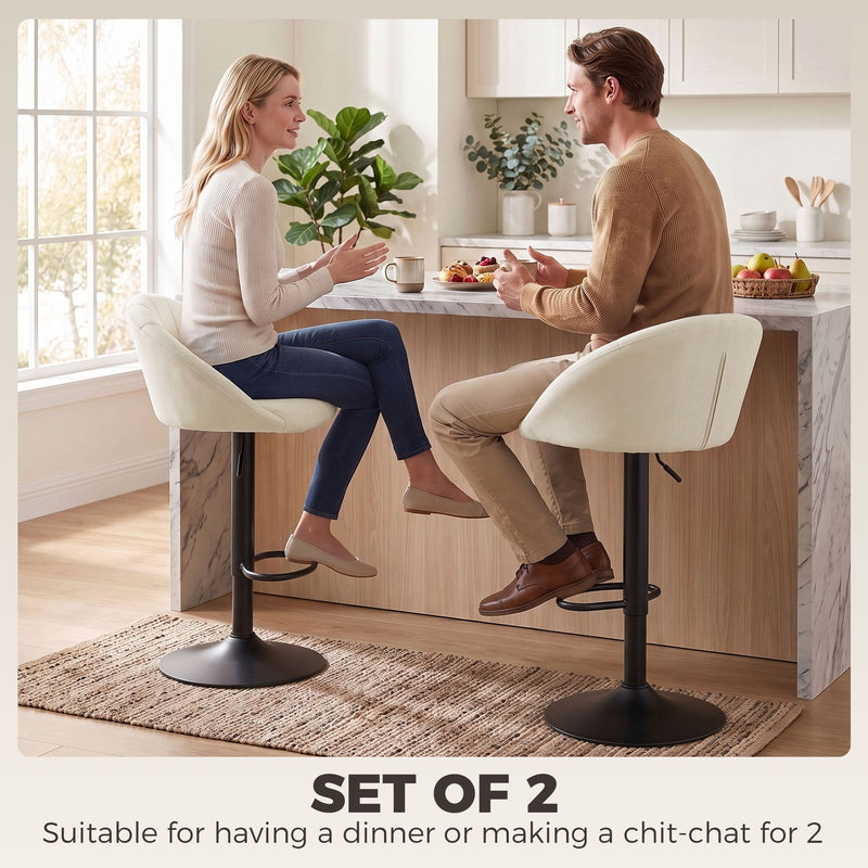 Couple chatting across a kitchen counter seated on cream white Homcom bar stools