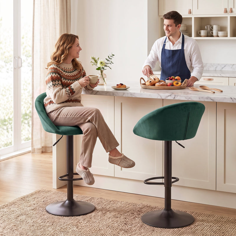 Woman sitting on a dark green Homcom bar stool at a marble kitchen island