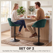Couple chatting across a kitchen counter seated on dark green Homcom bar stools
