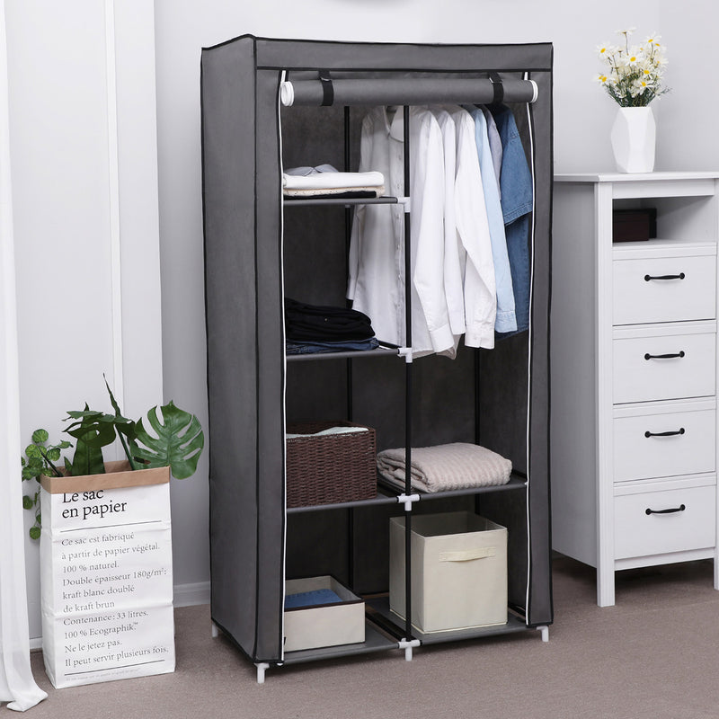 Grey canvas wardrobe with cover on in a bedroom next to a chest of drawers
