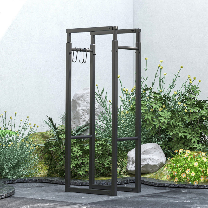 Log holder frame with hooks standing empty in a garden setting with rocks and plants