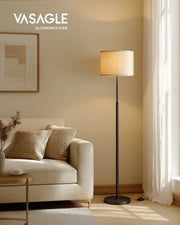Vasagle by Songmics Home Ink Black floor lamp lit beside a cream sofa