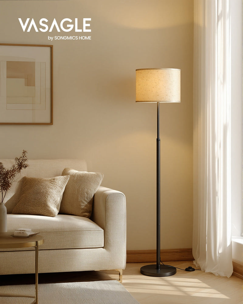 Vasagle by Songmics Home Ink Black floor lamp lit beside a cream sofa