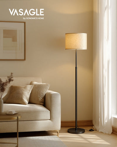 Vasagle by Songmics Home Ink Black floor lamp lit beside a cream sofa