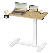 Studio view of the overbed table holding a laptop, tablet and cup
